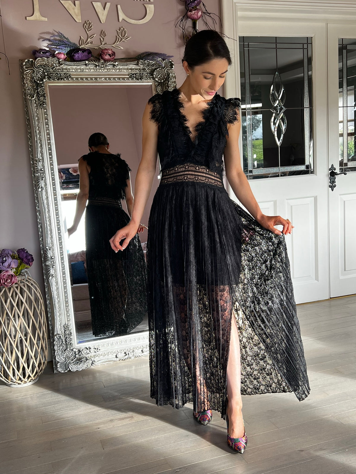 Avery, a black lace midi with a V neckline and a textured shoulder that adds structure.