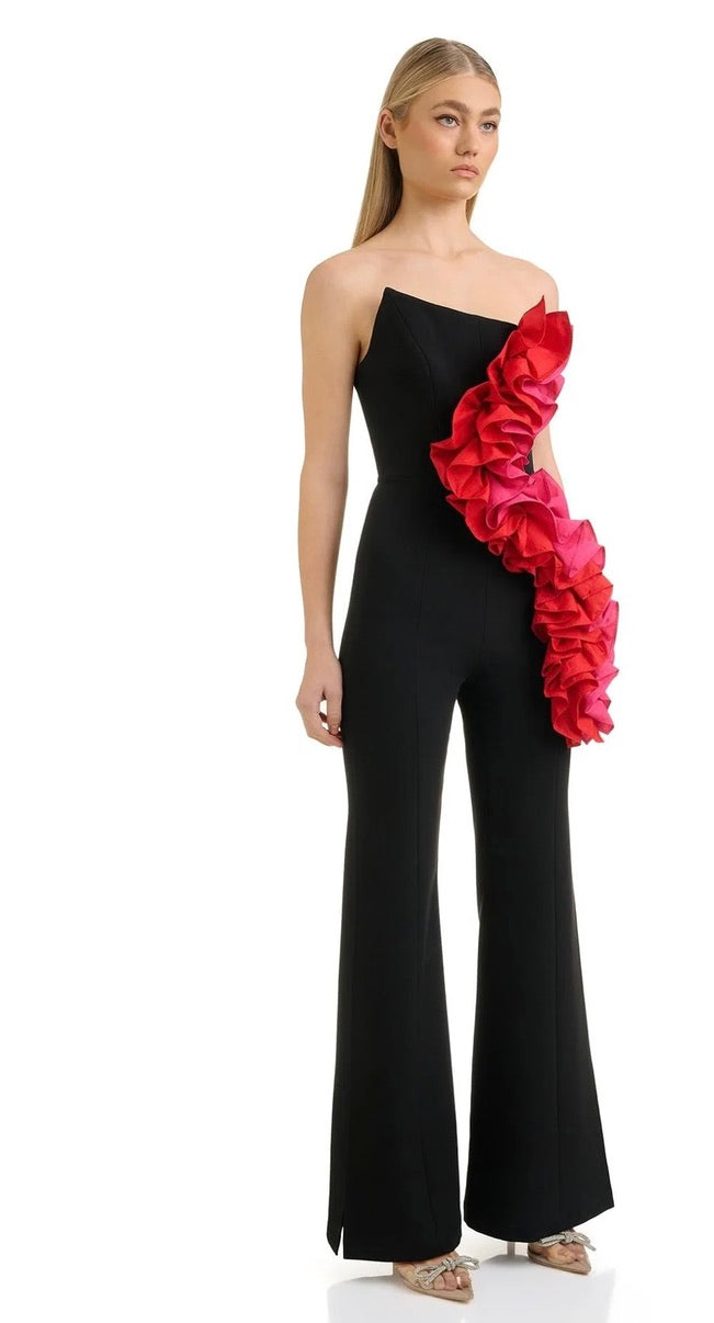 Brooke, a black jumpsuit with a strapless corseted top and colourful three dimensional floral rosettes.