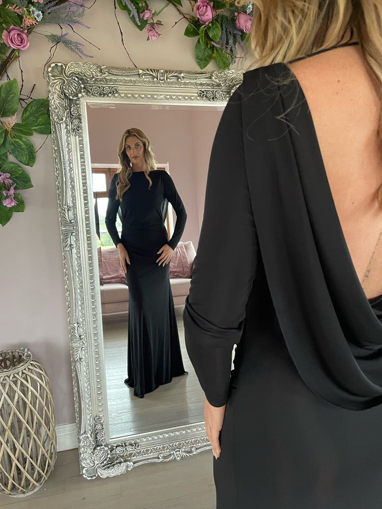 Sophia, a graceful full length black gown with long sleeves and a low cowl back.