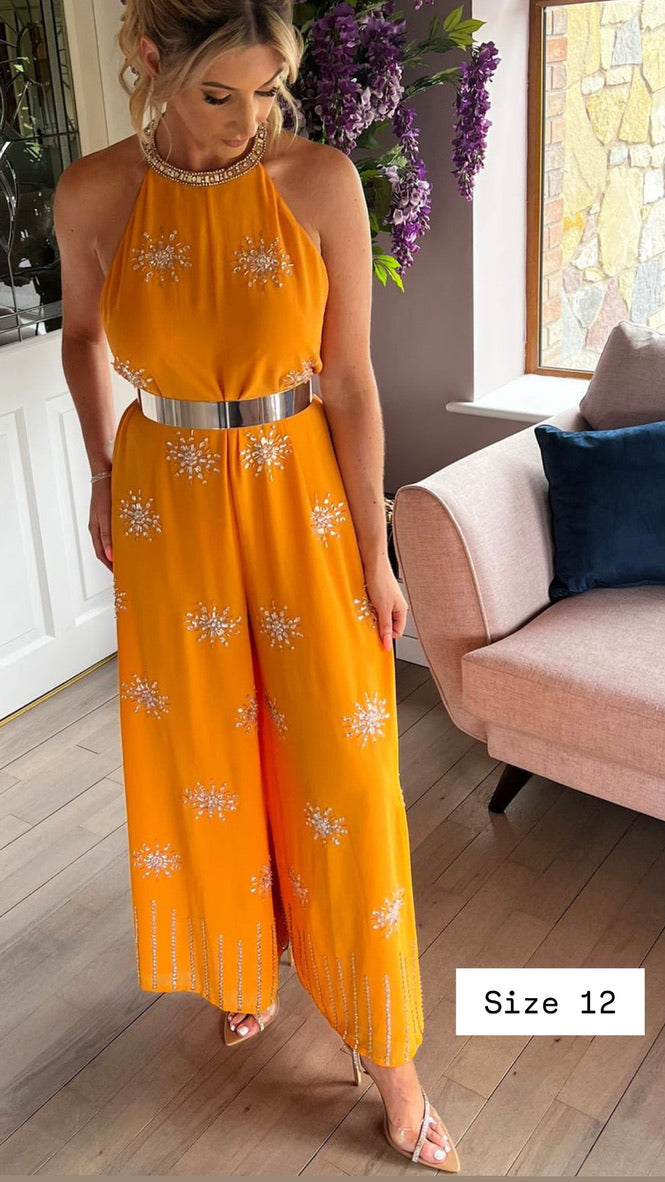 Sienna, orange jumpsuit, second view.