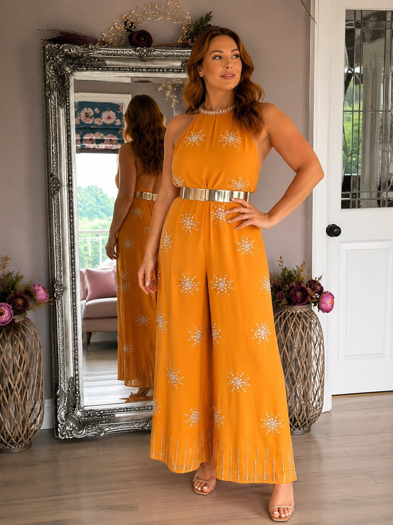 Sienna, a striking bright orange jumpsuit with a jewelled halter neckline and all over embellishment.