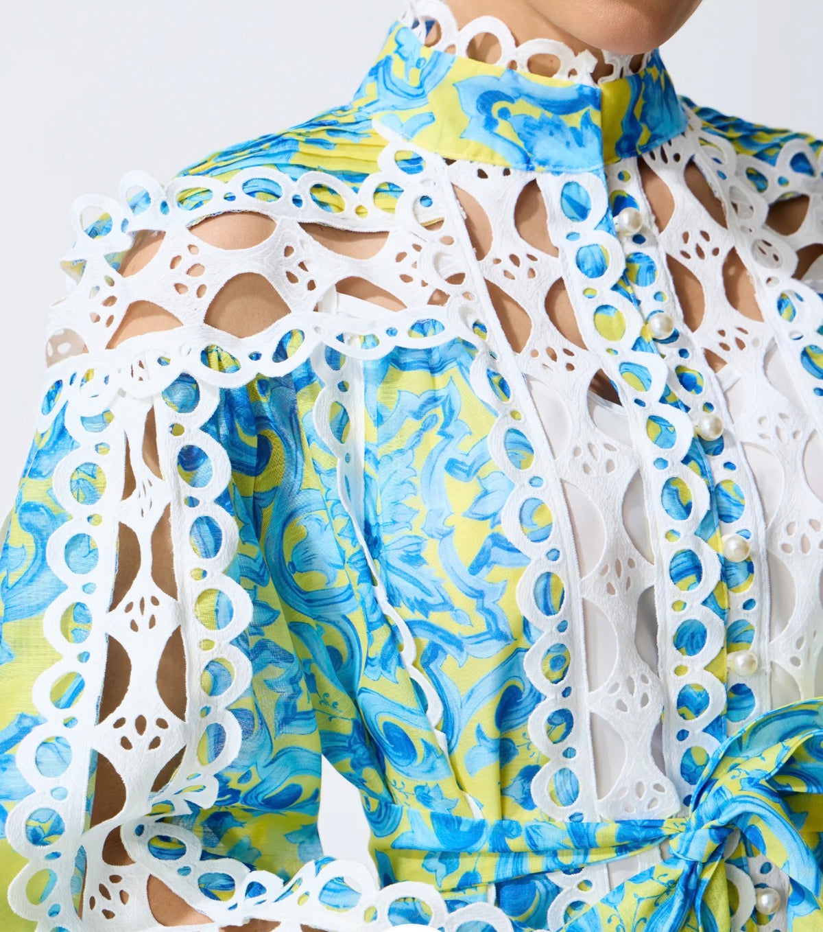 Audrey, a bold blue and yellow tile print mini with cream cutwork lace panels through the bodice, sleeves and skirt.