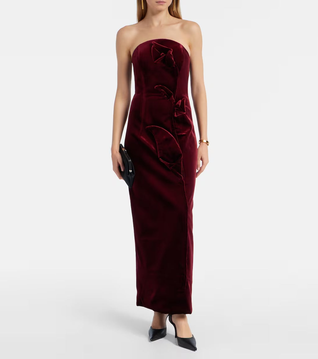 Valentina, a burgundy velvet column with a straight strapless neckline and sculptural rose appliqué.